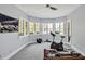 Bright exercise room with workout equipment, large windows showcasing peaceful views, and ample natural light at 25303 Ludwell, Chapel Hill, NC 27517