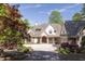 Charming traditional home with a manicured lawn, mature trees, and a welcoming front entrance at 25303 Ludwell, Chapel Hill, NC 27517