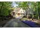 Inviting front exterior with manicured landscaping, a paved driveway, and a picturesque setting at 25303 Ludwell, Chapel Hill, NC 27517