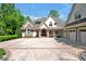 Stately home showcasing detailed brickwork, arched windows, manicured landscaping and a circular driveway at 25303 Ludwell, Chapel Hill, NC 27517