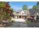 Elegant home exterior with a circular driveway, manicured landscaping, and a charming front entrance at 25303 Ludwell, Chapel Hill, NC 27517