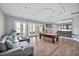 Spacious game room with a pool table, full bar, lounge seating, and doors leading to outdoor areas at 25303 Ludwell, Chapel Hill, NC 27517