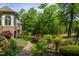 Exterior landscaped garden features stone pathway and a view of the home's exterior at 25303 Ludwell, Chapel Hill, NC 27517