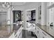 Gourmet kitchen with marble countertops and dark wood floors opens to living spaces at 25303 Ludwell, Chapel Hill, NC 27517