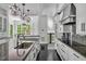 Gourmet kitchen with black-stained wood floors, white cabinets, and granite countertops at 25303 Ludwell, Chapel Hill, NC 27517