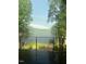 Scenic lake view with a bright rainbow, enhancing the natural beauty of the peaceful, wooded surroundings at 25303 Ludwell, Chapel Hill, NC 27517