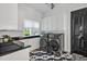 Stylish laundry room with black and white tile flooring, modern appliances, and ample storage space at 25303 Ludwell, Chapel Hill, NC 27517