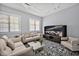 Comfortable living room with modern furniture, large windows, and an accent rug at 25303 Ludwell, Chapel Hill, NC 27517
