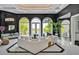 Bright living room with large windows, white sofas, and access to the outdoor balcony with lake views at 25303 Ludwell, Chapel Hill, NC 27517