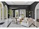 Expansive living room with modern décor, featuring large windows, bright lighting and white tile floors at 25303 Ludwell, Chapel Hill, NC 27517