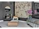 Living room with fireplace, marble accent wall, and mirrored cabinet with modern decor at 25303 Ludwell, Chapel Hill, NC 27517