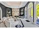 Elegant living room features a fireplace, arched windows, marble accent wall and sleek modern furnishings at 25303 Ludwell, Chapel Hill, NC 27517