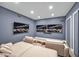 Relaxing media room featuring comfortable seating, two large screens, and recessed lighting for an immersive experience at 25303 Ludwell, Chapel Hill, NC 27517