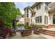Charming outdoor patio with wicker furniture, umbrella, and lush landscaping at 25303 Ludwell, Chapel Hill, NC 27517