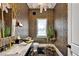 Stylish powder room with bold wallpaper, gold fixtures, and a floating vanity at 25303 Ludwell, Chapel Hill, NC 27517