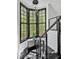 Modern staircase with stainless steel cable railing and a window nook overlooking the trees at 25303 Ludwell, Chapel Hill, NC 27517