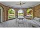 Charming sunroom with brick archways offering picturesque views of the lake and surrounding greenery at 25303 Ludwell, Chapel Hill, NC 27517