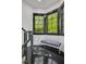 Bright window nook with modern striped bench, black trim, and views of the surrounding lush greenery at 25303 Ludwell, Chapel Hill, NC 27517