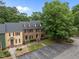 Neighborhood aerial view featuring traditional townhouses, mature trees, and ample parking at 3100 Coachmans Way, Durham, NC 27705