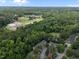 Aerial view of townhomes and the surrounding area with mature trees at 3100 Coachmans Way, Durham, NC 27705