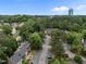 Beautiful aerial view of a neighborhood, townhouses, lush greenery, and distant office tower at 3100 Coachmans Way, Durham, NC 27705