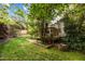 Charming backyard view with a wooden deck, lush green lawn, and beautiful landscaping at 3100 Coachmans Way, Durham, NC 27705
