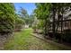 Manicured backyard showing exterior of home and wooden deck at 3100 Coachmans Way, Durham, NC 27705