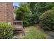 Exterior of home showing deck, brick, yard, and basement access at 3100 Coachmans Way, Durham, NC 27705