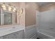 Well-lit bathroom features a vanity with a sink, mirror and a bathtub with white tiles at 3100 Coachmans Way, Durham, NC 27705