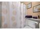 Clean bathroom featuring a shower with patterned curtain, toilet, and decorative accents at 3100 Coachmans Way, Durham, NC 27705