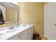 Quaint bathroom with floral wallpaper and a functional vanity at 3100 Coachmans Way, Durham, NC 27705