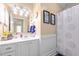 Well-lit bathroom with white vanity, decorative mirror, and shower-tub combination at 3100 Coachmans Way, Durham, NC 27705