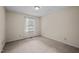 Bedroom featuring neutral walls, soft carpeting, and a window for natural light at 3100 Coachmans Way, Durham, NC 27705