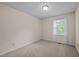 Bright bedroom with a neutral color scheme, a window, and soft carpeting at 3100 Coachmans Way, Durham, NC 27705