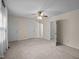 Expansive bedroom features neutral walls and carpet, complemented by a ceiling fan and multiple closets at 3100 Coachmans Way, Durham, NC 27705