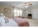 Bright and airy bedroom with a ceiling fan, comfortable bed, and sheer curtains at 3100 Coachmans Way, Durham, NC 27705