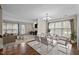 Bright dining room featuring a glass table, stylish seating, and an open layout connecting to the living area at 3100 Coachmans Way, Durham, NC 27705