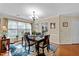 Inviting dining room with wood floors, chandelier and natural light from a large window at 3100 Coachmans Way, Durham, NC 27705