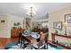Open concept dining room with wood floors and views of the living room and staircase at 3100 Coachmans Way, Durham, NC 27705