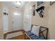 Inviting entryway with a coat rack and padded bench adjacent to the front door at 3100 Coachmans Way, Durham, NC 27705