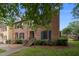 Beautiful brick townhome with blue shutters and manicured landscaping at 3100 Coachmans Way, Durham, NC 27705