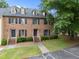 Brick townhome with dormer windows, well-maintained lawn, and a welcoming entryway at 3100 Coachmans Way, Durham, NC 27705