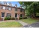 Brick townhome with blue shutters and a well-maintained front lawn at 3100 Coachmans Way, Durham, NC 27705