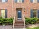 Inviting front entrance with brick steps, wooden railings, and lush green landscaping at 3100 Coachmans Way, Durham, NC 27705