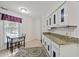 Bright eat-in kitchen featuring tile floors, granite counters, and updated cabinets at 3100 Coachmans Way, Durham, NC 27705