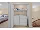 Functional laundry area with a washer, dryer, and storage shelf, conveniently located near the stairs at 3100 Coachmans Way, Durham, NC 27705