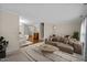 Spacious living room with plush carpet, comfortable sofa, and a seamless transition to the dining area at 3100 Coachmans Way, Durham, NC 27705