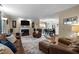 Open-concept living room with a fireplace, hardwood floors, and dining area with natural light at 3100 Coachmans Way, Durham, NC 27705