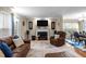 Cozy living room featuring a fireplace with mounted television, leather furnishings, and hardwood floors at 3100 Coachmans Way, Durham, NC 27705