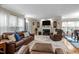 Comfortable living room with a fireplace, leather furniture, and lots of natural light at 3100 Coachmans Way, Durham, NC 27705